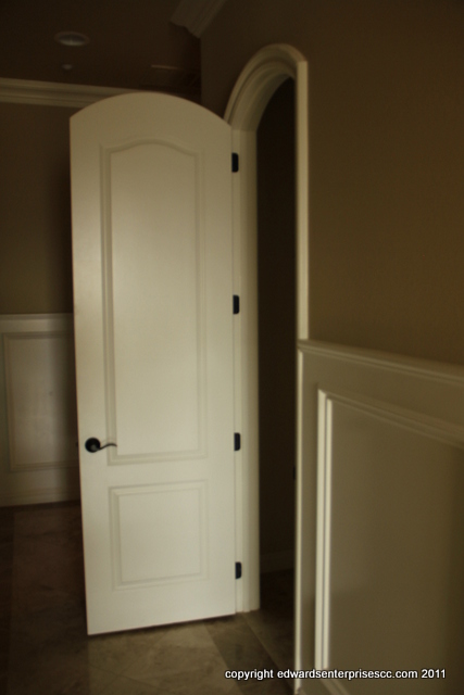 Somis Door Repair Service: An interior arched paneled hollow core door repaired to cover up a hole. Primed and painted. Edward's Enterprises