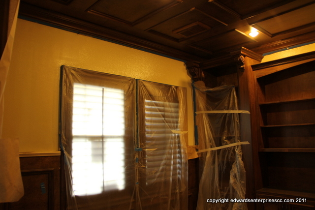 Masking, taping and protecting a stained poplar bookcase and desk while patching, texturing and painting an office in the home of one of our painting customers.