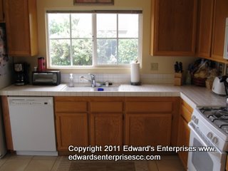 A residential kitchen remodel project including tile, cabinet repair, drywall, painting, and more: Edward’s Enterprises Kitchen Remodels.