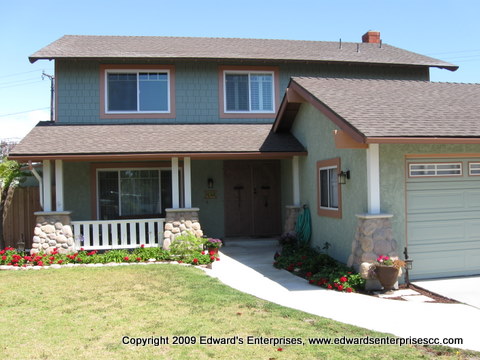 Exterior Residential Facade Remodel: New posts, window trim, porch, stonework, sidewalk, paint, siding, front screen doors, and more.