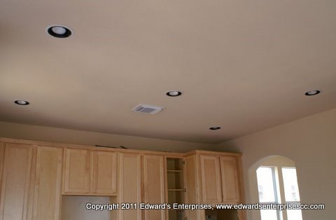 Residential remodeling involving recessed lighting in a kitchen