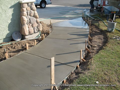 Residential Remodeling: Exterior of a home remodeled to add curb appeal and change the aethstetic of the home including this concrete walkway