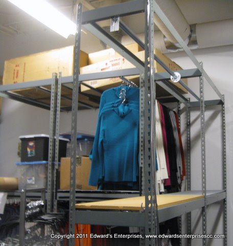 Edward’s enterprises retail rack service: retail sales fixture clothes racks secured to wall and installed at a retail location.