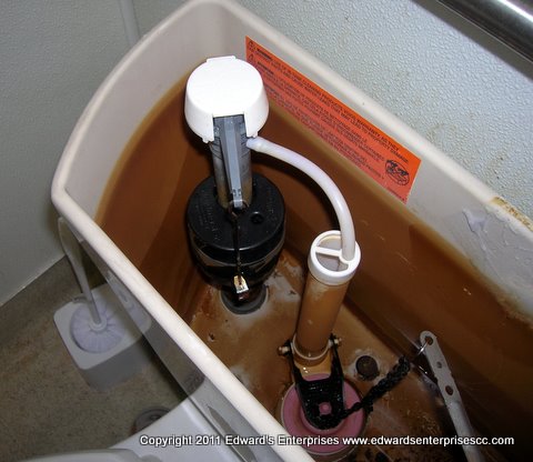 An open Lake Sherwood toilet bowl top with valves and pulley.