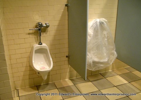 Edward’s Enterprises Urinal Service: Store urinal repair job in progress.