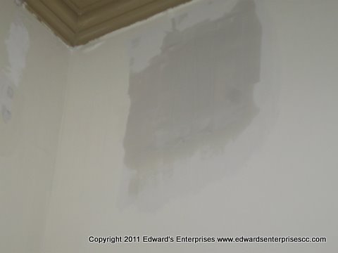 A residential wall patch job, near the ceiling.