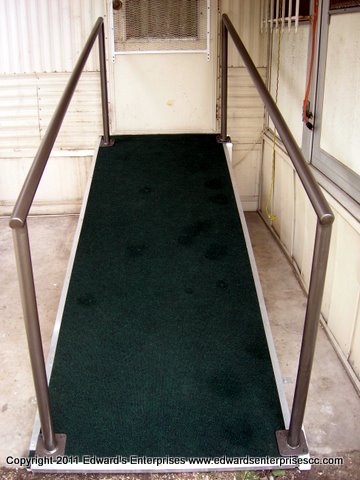 Edward’s Enterprises Wood Ramp Service: Wood ramp repairs and installations: A wooden wheelchair ramp outside a home allows convenient exit and entry for anybody.