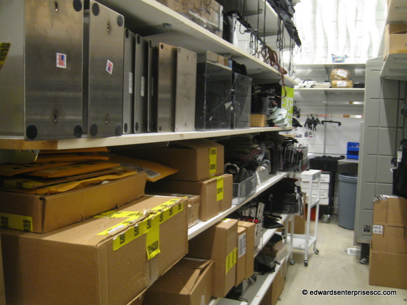 Edward’s enterprises retail rack service: retail sales fixture clothes racks secured to wall and installed at a retail location.