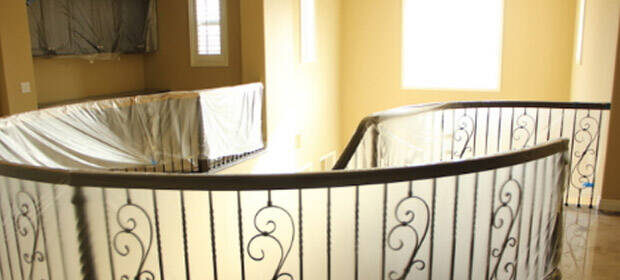 Circular stairway railing, draped in translucent plastic: Edward's Enterprises Remodel Contractor & Handyman Service