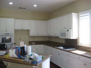 Kitchen with white cabinets being remodeled, after wallpaper removed