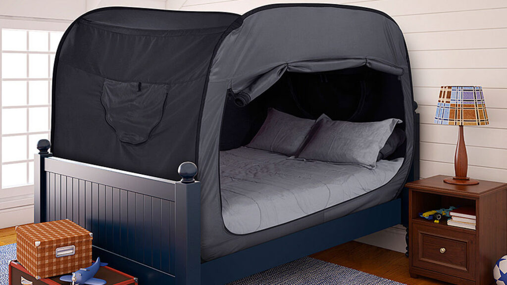 Bed with tent enclosure in child's bedroom