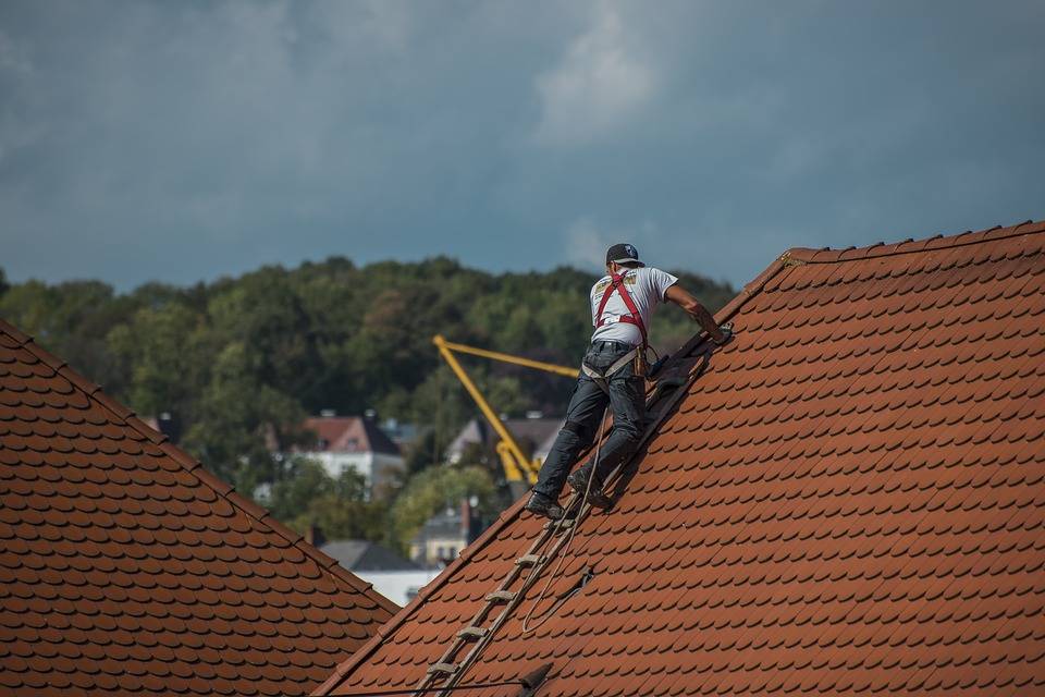 Roofer repairing steep roof