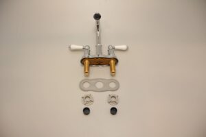 Faucet laid out in parts, with plastic nuts, washers, and gasket