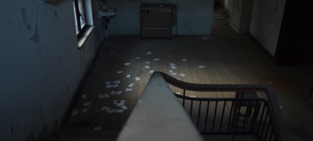 Inside of old, abandoned building from top of stairs