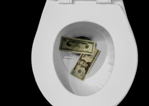 20 US dollar banknotes on toilet bowl