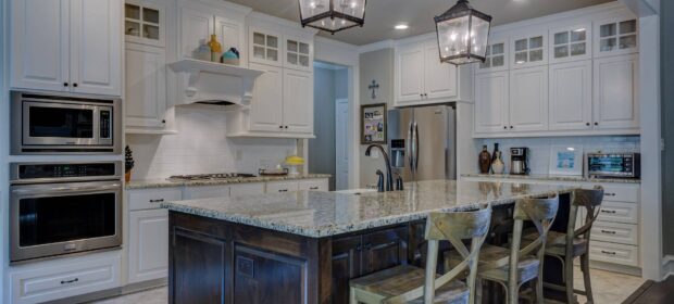 White kitchen with island and marble countertops