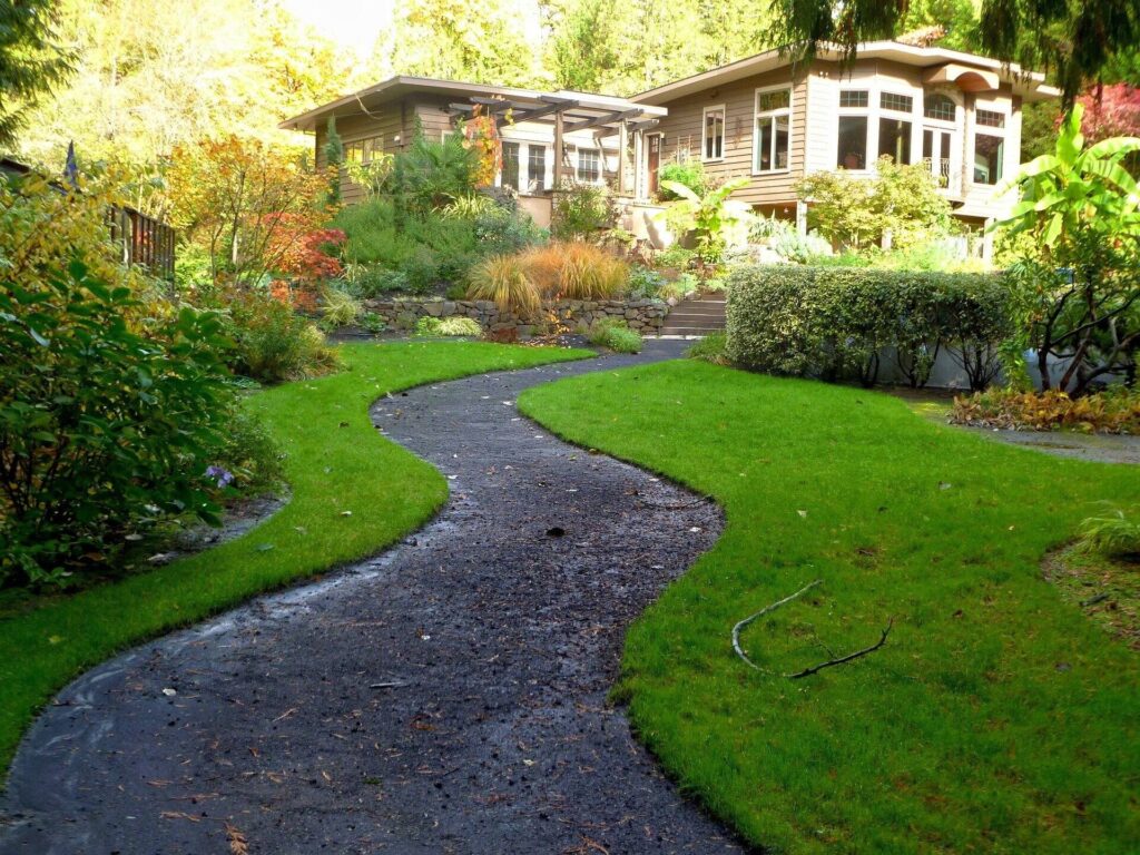 Nice little fancy/rustic house with path leading to it with lawn and garden on both sides